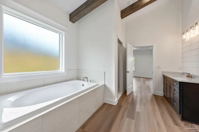 a spacious bathroom with a tub and a sink