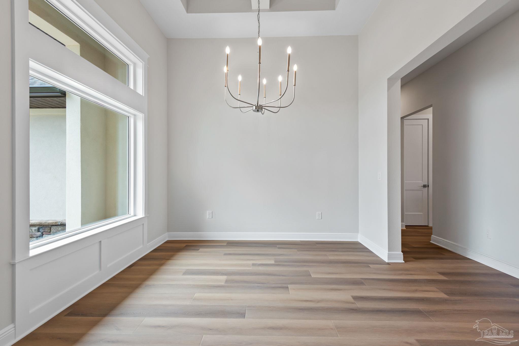 2038 Fontainebleau Court Navarre, FL 32566 - Photo 6 of 8 a view of an empty room with wooden floor and window