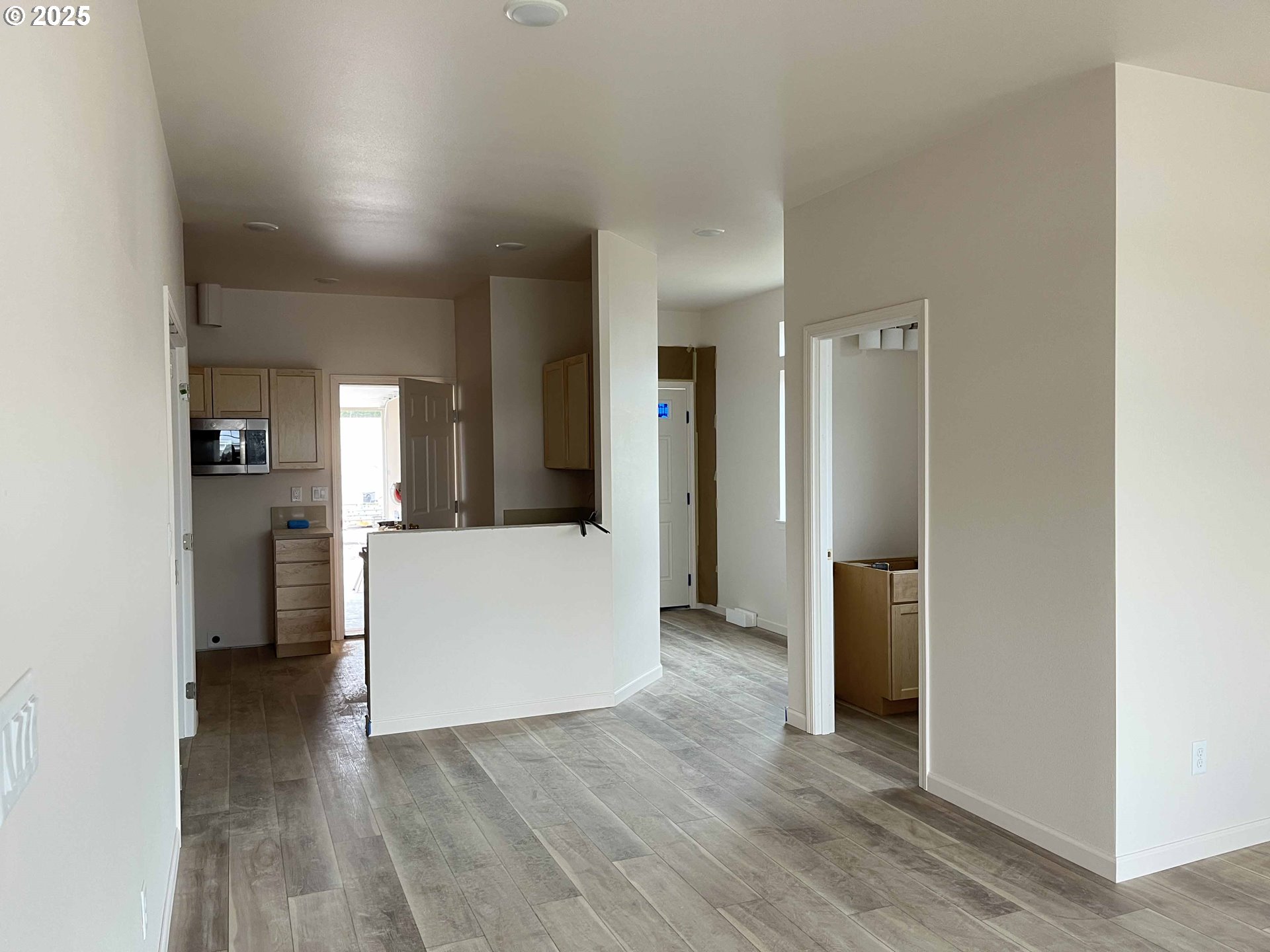 1583 37th Street Florence, OR 97439 - Photo 32 of 48 a view of a kitchen refrigerator and wooden floor