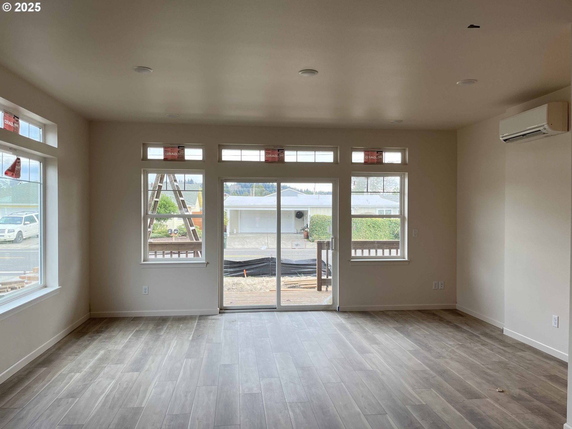 1583 37th Street Florence, OR 97439 - Photo 33 of 48 a view of an empty room with a window and wooden floor