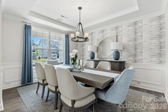 a living room with furniture a rug and a large window