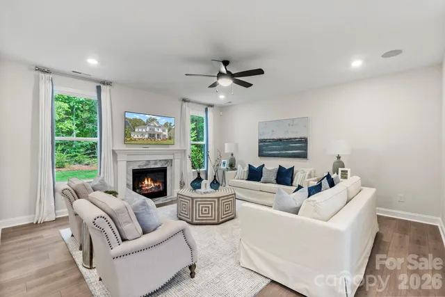 a living room with furniture a ceiling fan and a rug