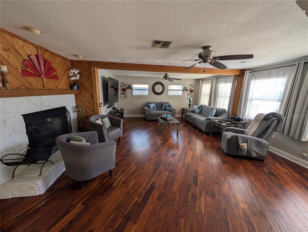 5508 Bryson Drive Orlando, FL 32818 - Photo 13 of 69 a living room with furniture and a fireplace