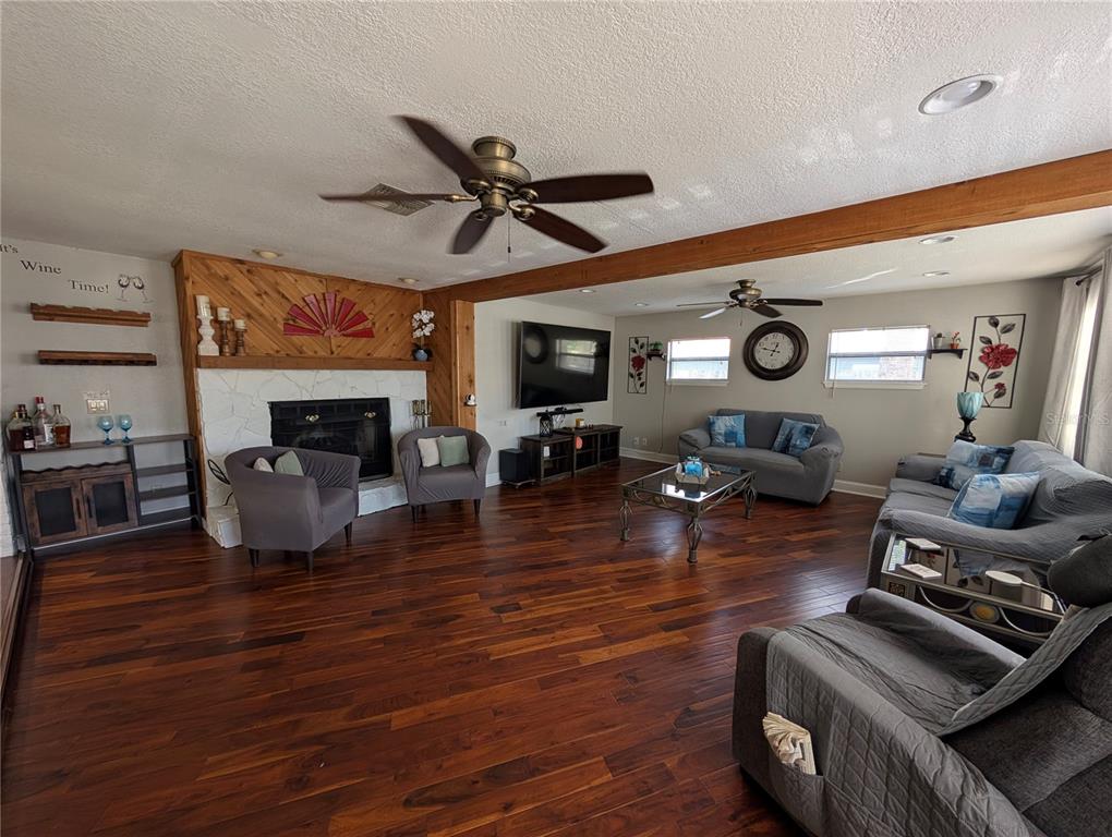 5508 Bryson Drive Orlando, FL 32818 - Photo 15 of 69 a living room with furniture and a fireplace