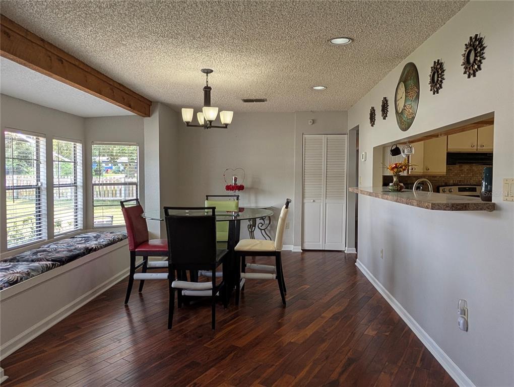5508 Bryson Drive Orlando, FL 32818 - Photo 23 of 69 a view of a dining room with furniture window and wooden floor