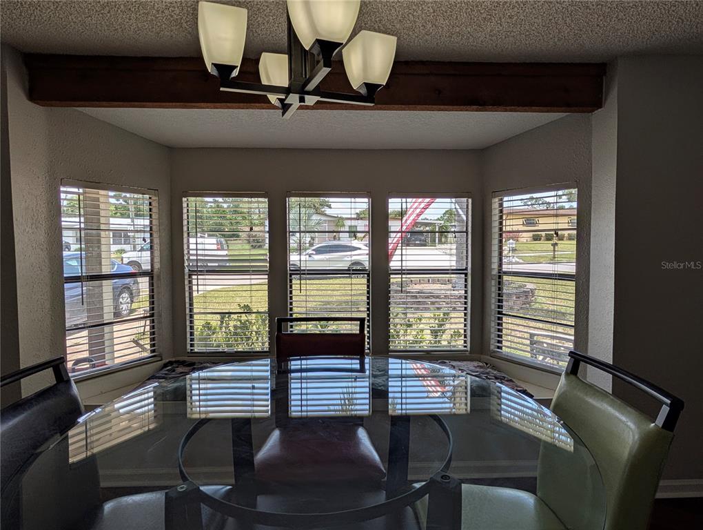 5508 Bryson Drive Orlando, FL 32818 - Photo 25 of 69 a living room with furniture and floor to ceiling windows