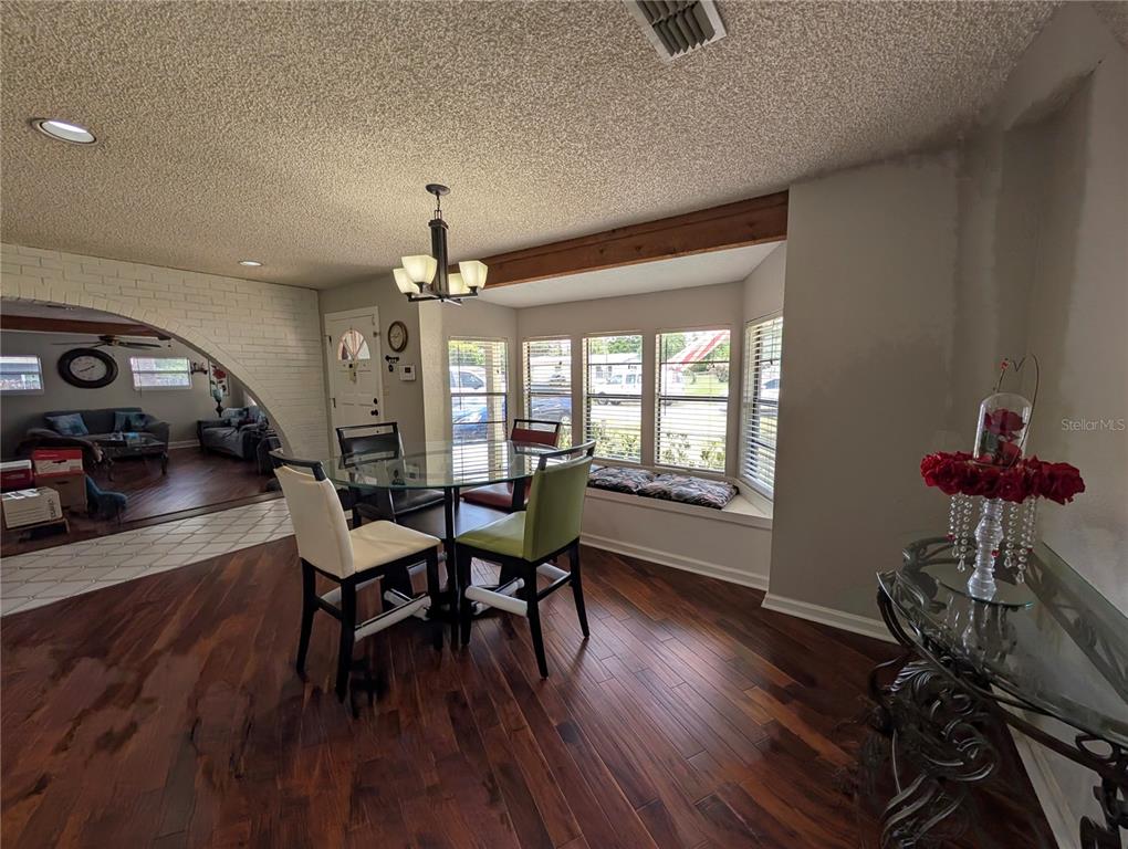 5508 Bryson Drive Orlando, FL 32818 - Photo 26 of 69 a view of a dining room with furniture window and wooden floor