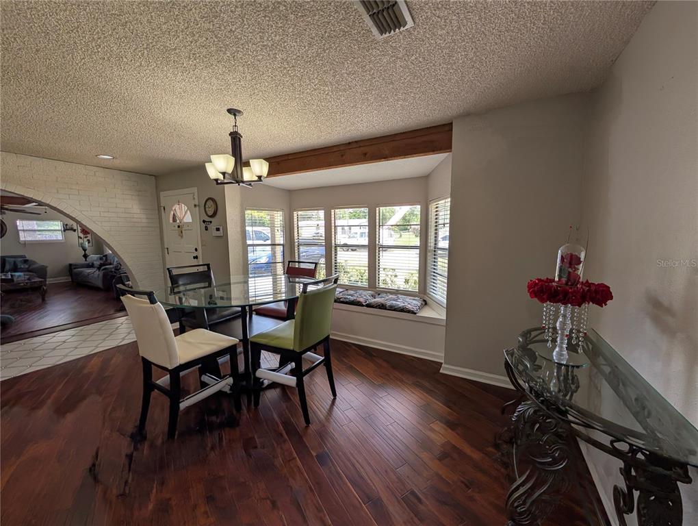 5508 Bryson Drive Orlando, FL 32818 - Photo 27 of 69 a view of a dining room with furniture window and wooden floor