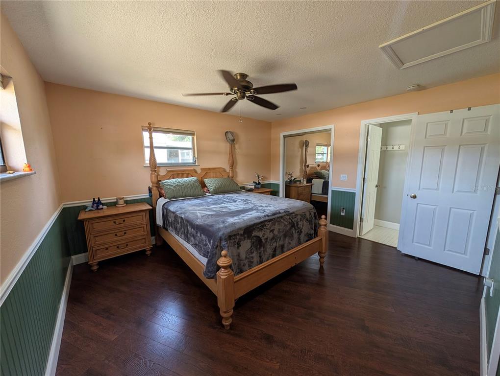 5508 Bryson Drive Orlando, FL 32818 - Photo 38 of 69 a bedroom with a bed and wooden floor