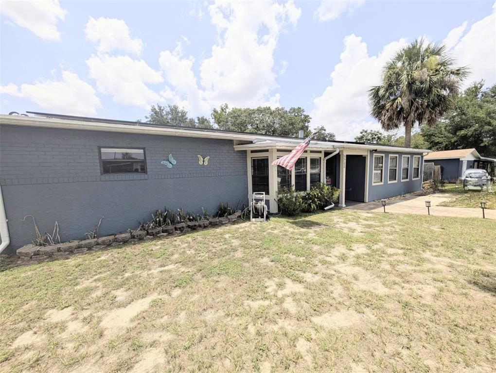 5508 Bryson Drive Orlando, FL 32818 - Photo 4 of 69 a backyard of a house with table and chairs under an umbrella