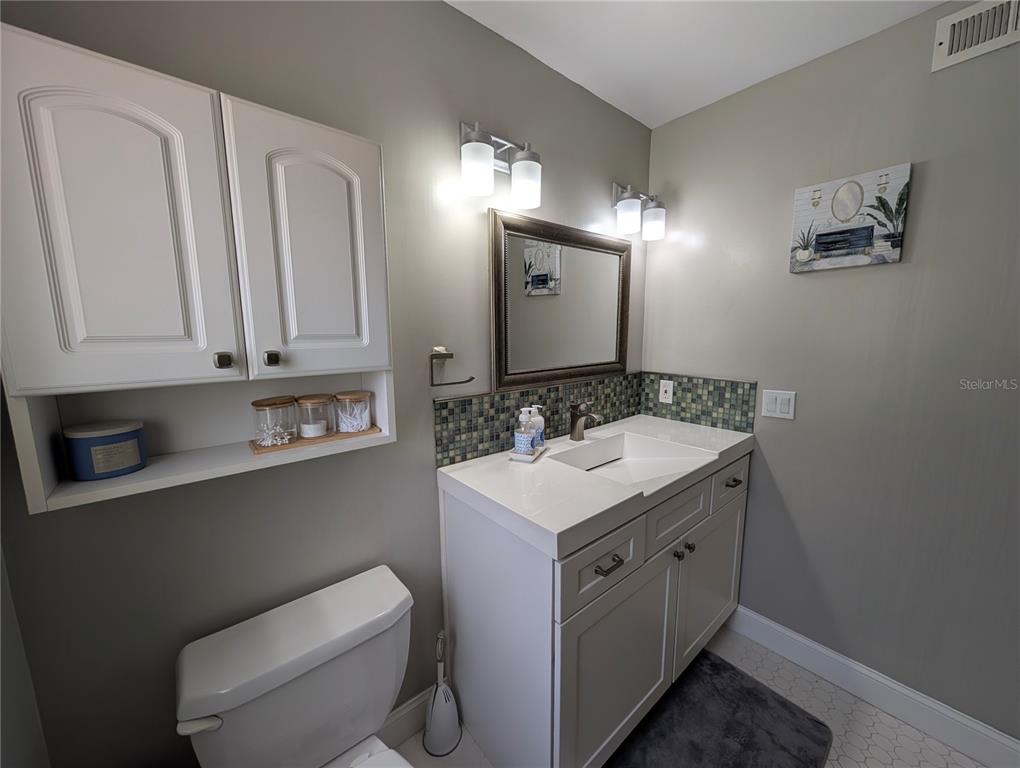 5508 Bryson Drive Orlando, FL 32818 - Photo 43 of 69 a bathroom with a toilet sink and mirror