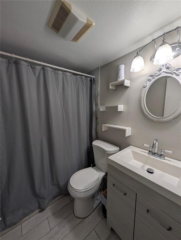 5508 Bryson Drive Orlando, FL 32818 - Photo 49 of 69 a bathroom with a toilet a sink and a mirror