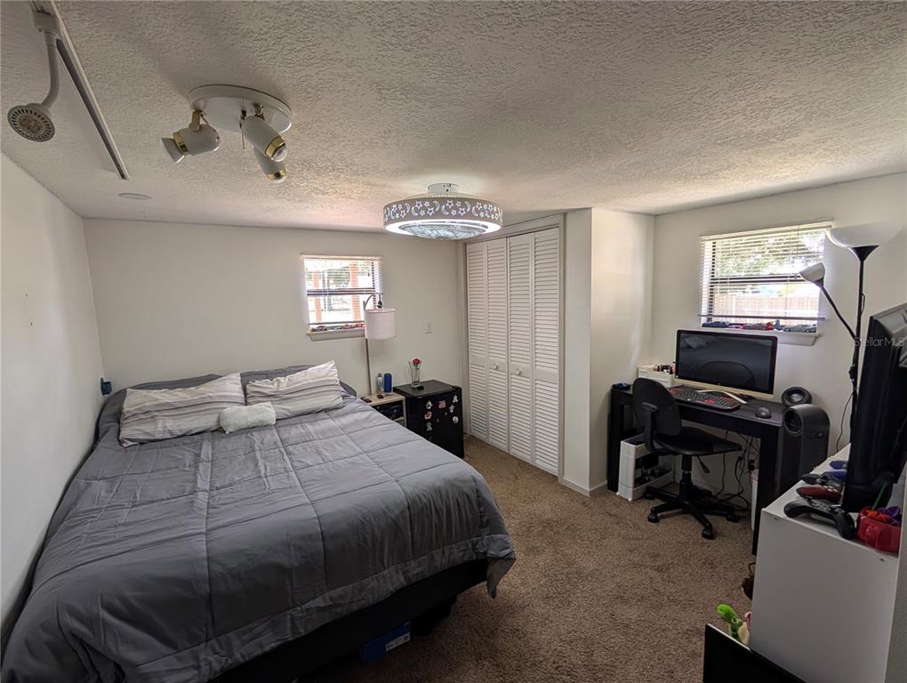 5508 Bryson Drive Orlando, FL 32818 - Photo 52 of 69 a bedroom with a bed and a window