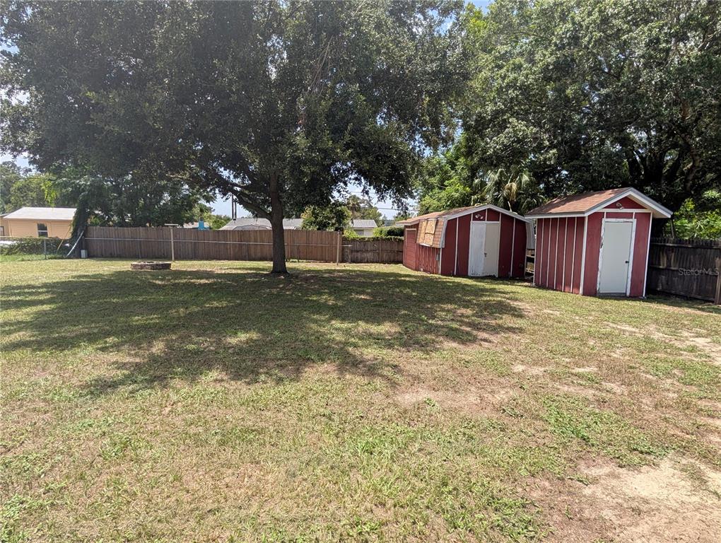 5508 Bryson Drive Orlando, FL 32818 - Photo 57 of 69 a view of a backyard with a house and large tree