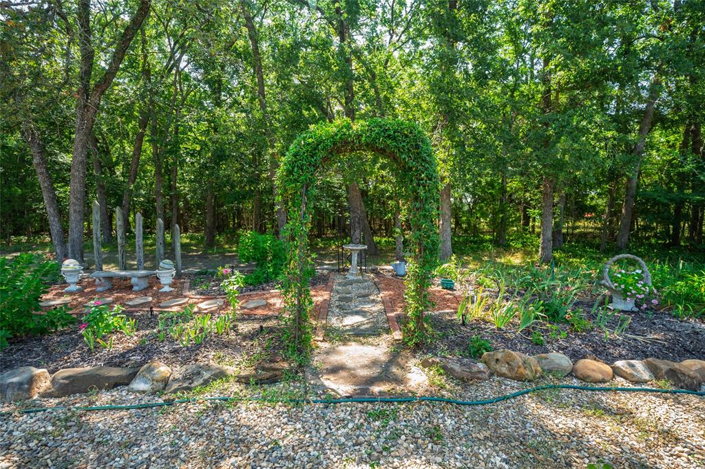 1516 Rancho Road Quinlan, TX 75474 - Photo 33 of 40 a backyard of a house with lots of green space