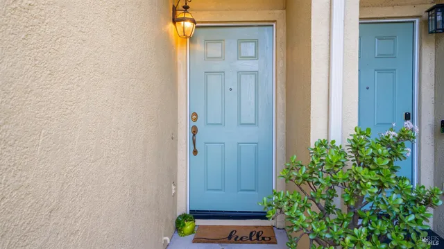 an empty room with windows and fireplace