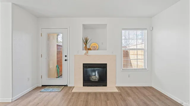 wooden floor in an empty room with a window