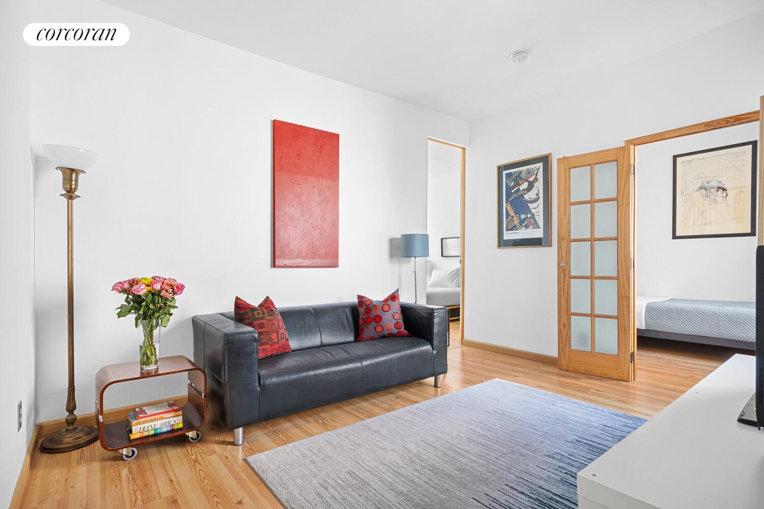 a living room with furniture and wooden floor
