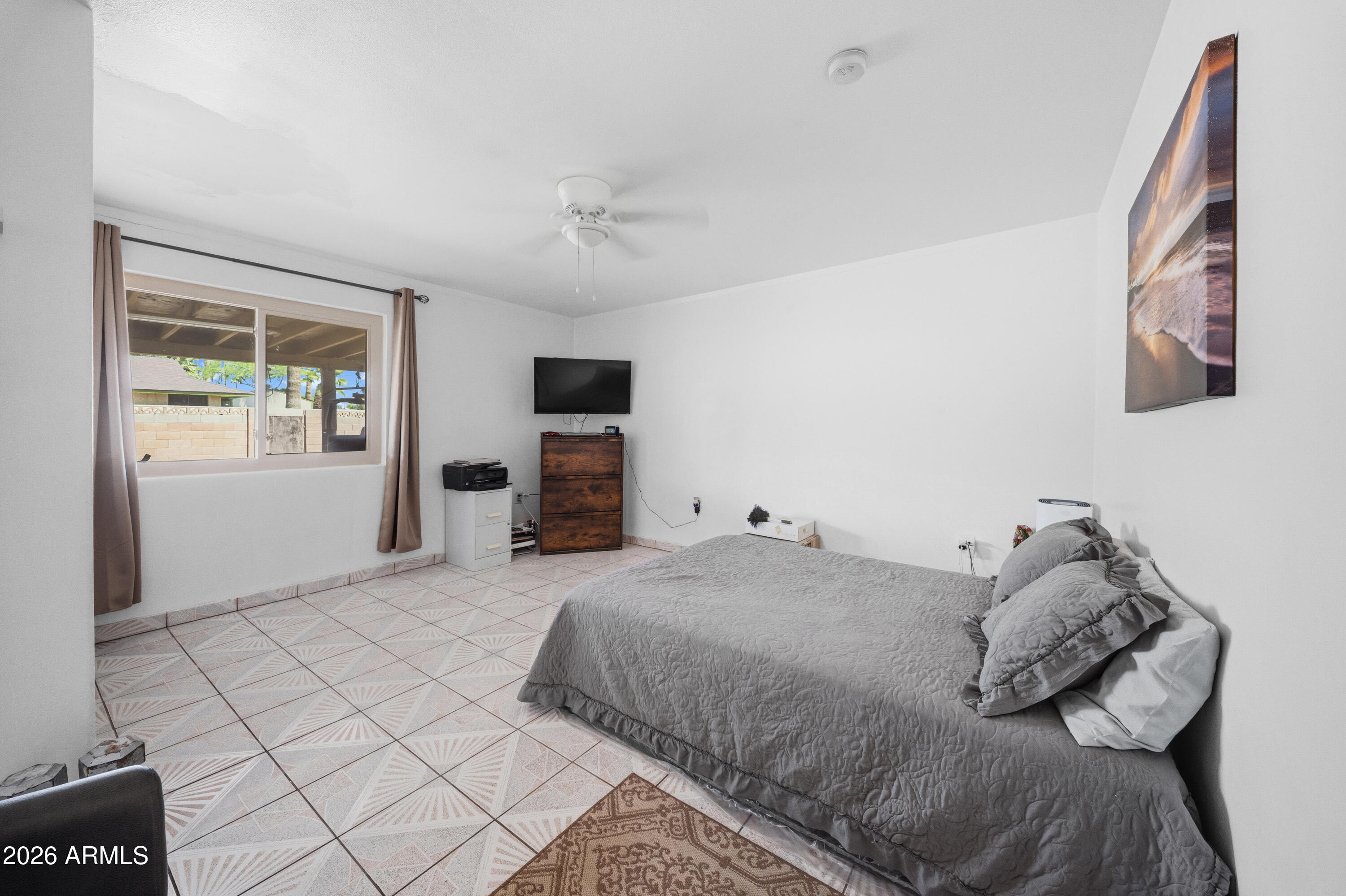 3902 West Monte Vista Road Phoenix, AZ 85009 - Photo 12 of 29 a bedroom with a bed and a tv on the dresser