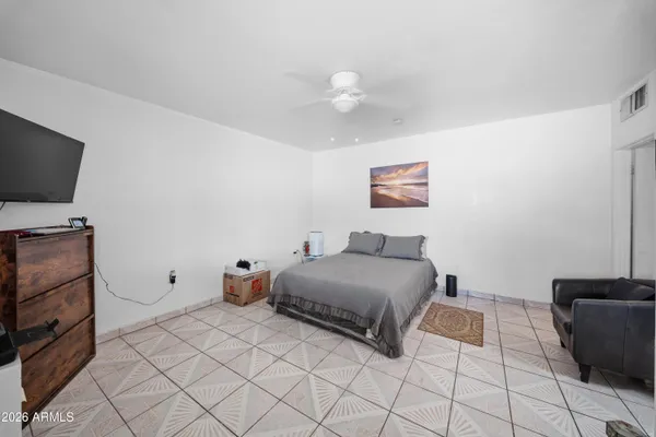 a bedroom with a bed and a television