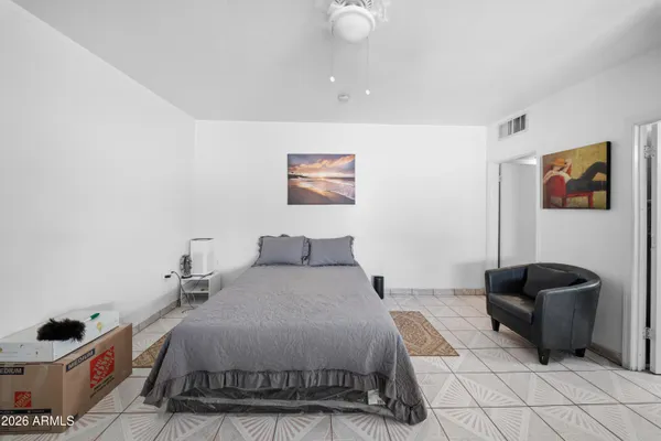 a bedroom with a bed and a couch