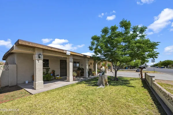 a view of a house with yard and sitting area