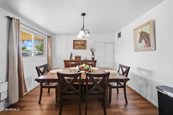 a view of a dining room with furniture window and wooden floor