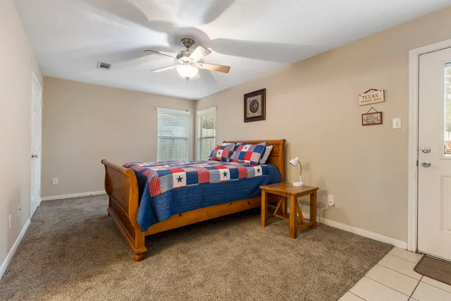 a view of a backyard with table and chairs and wooden fence