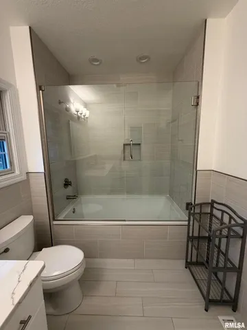 a bathroom with a toilet and a shower