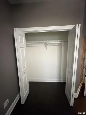 a room with a bed and a painting on the wall