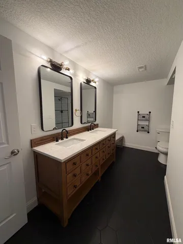 a room with a bed furniture and mirror