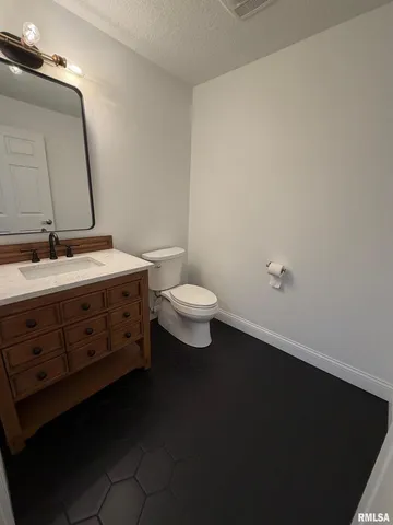 a view of walk in closet with wooden floor and chair