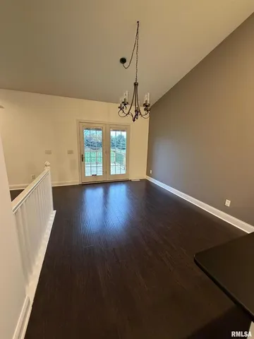 a view of a room with wooden floor and window