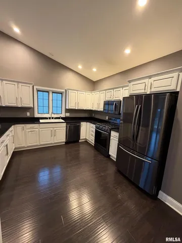 a kitchen with granite countertop stainless steel appliances and wooden cabinets