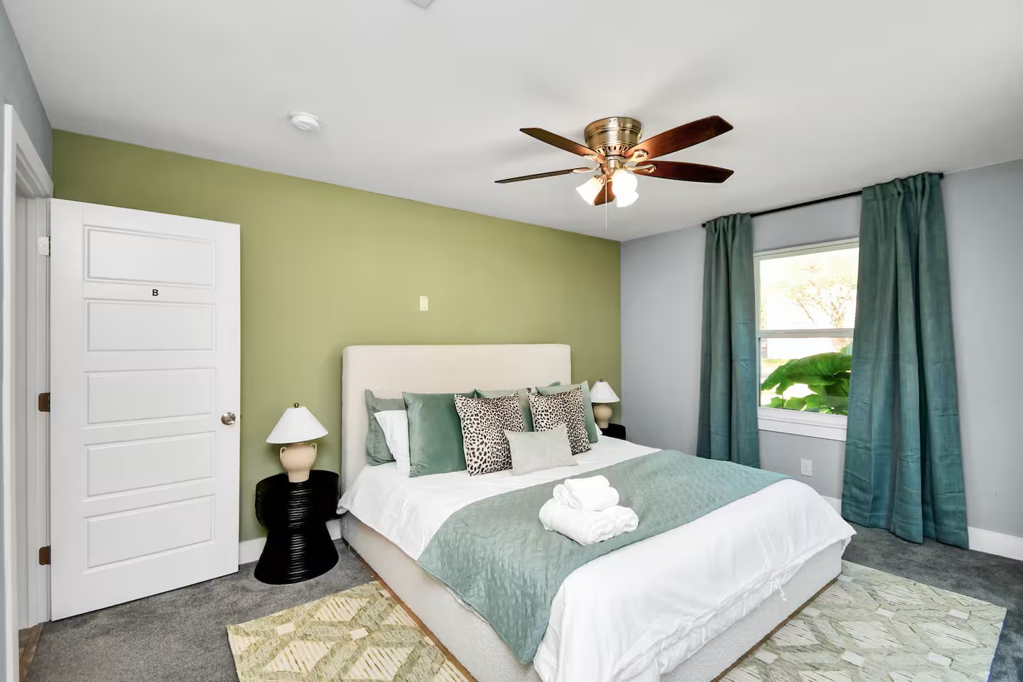 3318 Wichita Street Houston, TX 77004 - Photo 11 of 36 a bedroom with a bed and a chandelier