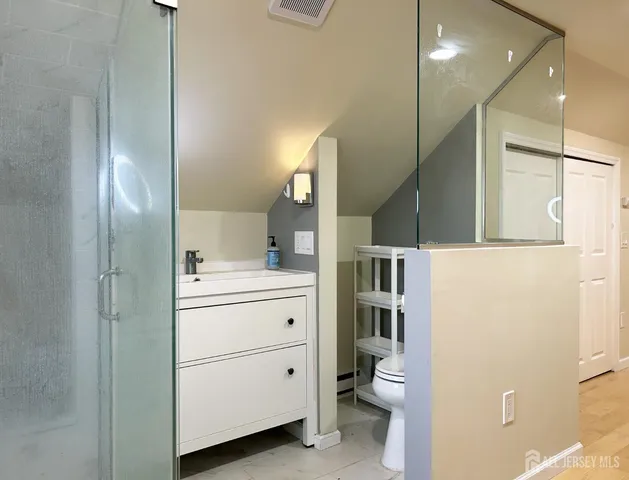 a bathroom with a sink a toilet and a mirror