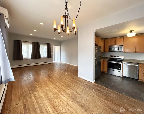 a view of a kitchen with a sink and stainless steel appliances