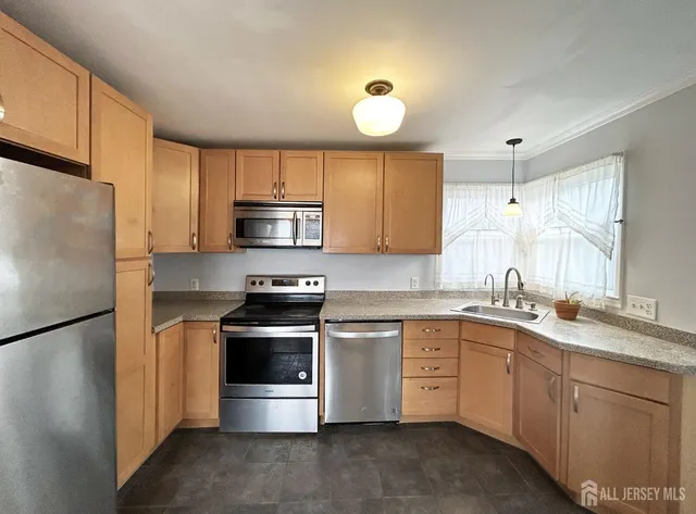a kitchen with a sink stove and refrigerator
