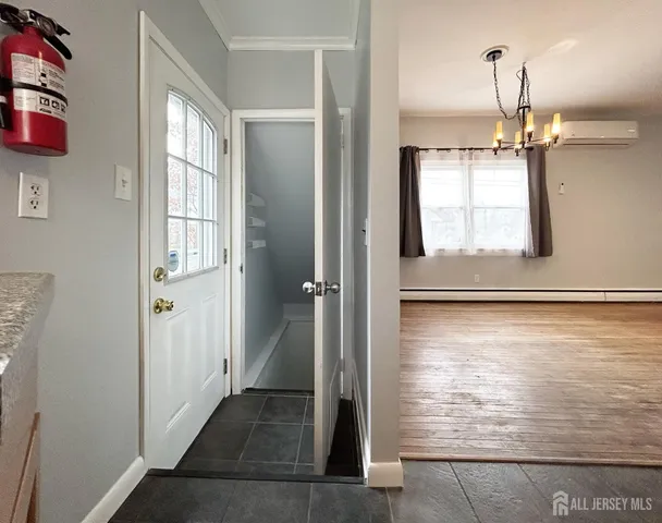 a view of empty room with wooden floor and windows