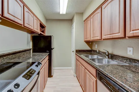 a kitchen that has a sink and a stove