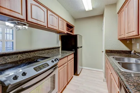 a kitchen with stainless steel appliances granite countertop a stove and a microwave