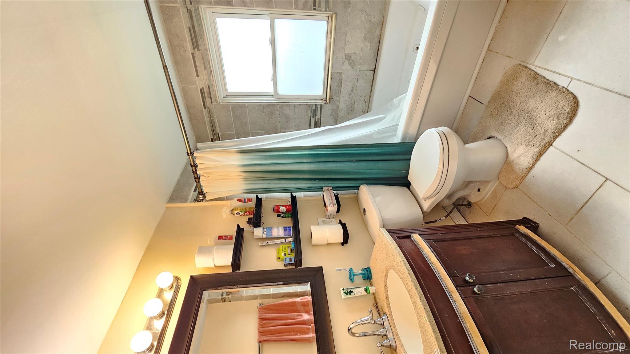 1818 Milverton Road Troy, MI 48083 - Photo 18 of 22 Bathroom with vanity, shower / bath combo with shower curtain, and light tile patterned floors