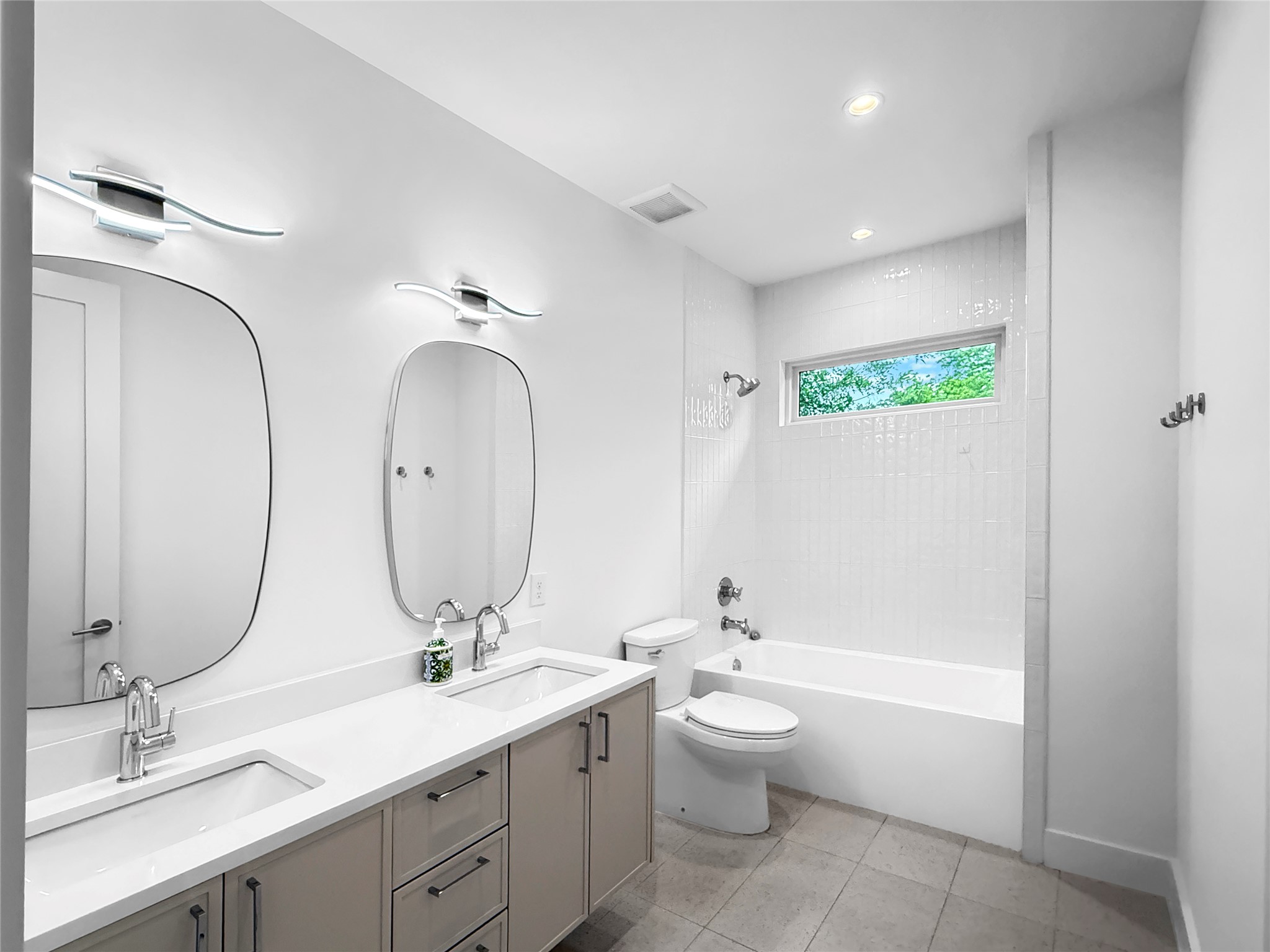 127 Frederick Street Austin, TX 78704 - Photo 26 of 34 Bathroom featuring a double vanity with stone countertops, individual vessel sinks, and contemporary faucets