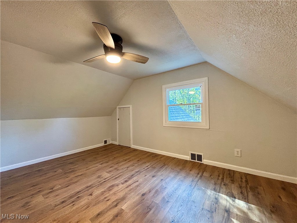 3522 Tent Church Road Colliers, WV 26035 - Photo 14 of 27 Additional living space with a textured ceiling, wood finished floors, vaulted ceiling, and a ceiling fan