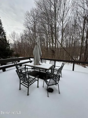 a view of an outdoor sitting area with couch and wooden fence