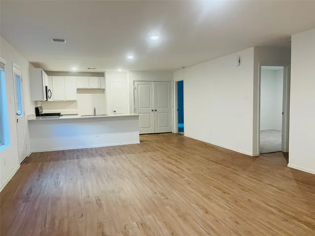 a view of a kitchen with wooden floor