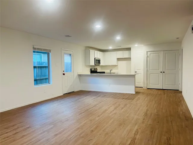 a view of a kitchen with a sink and a stove top oven