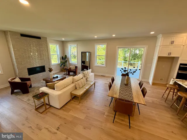 a living room with furniture rug and wooden floor