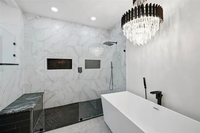 a bathroom with a sink a mirror and bathtub