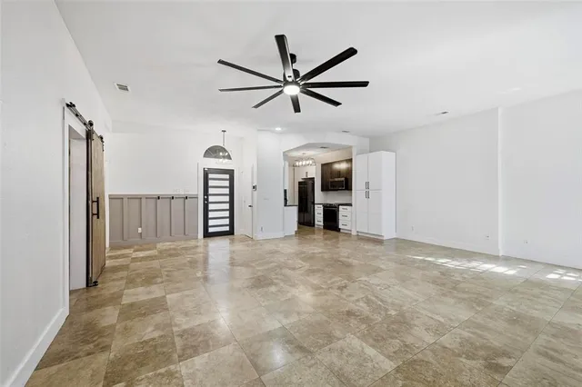 a view of a livingroom with a ceiling fan and window